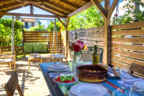 a table with plates of food on a patio at Christinas apartments in Ágios Matthaíos