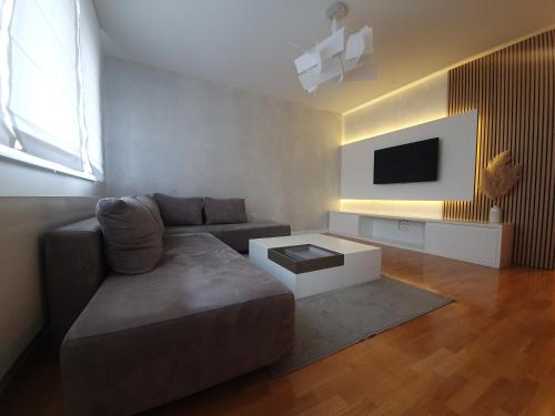 a living room with a couch and a tv at Apartment I Love Zagreb, free private parking in Zagreb