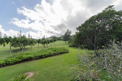 a park with palm trees and a green field at Turtle Bay Hale Lani Condo in Kahuku