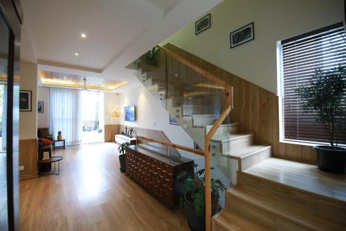 a living room with a staircase in a house at Alpviram Villa, 4 Bhk En-suite villa with elevator in Kasauli