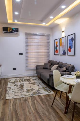 a living room with a couch and a table at Milano Apartment in Abuja
