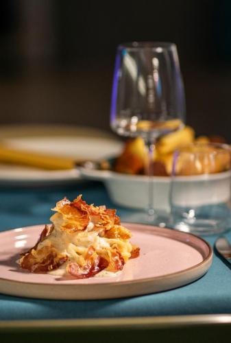 a piece of food on a plate on a table at Arryvo Hotel in Lecce