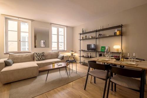 a living room with a couch and a table at Rare Appart 2 chambres en duplex design au Panier in Marseille