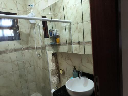 een badkamer met wastafel en douche bij Casa em Condomínio Martin de Sa in Caraguatatuba