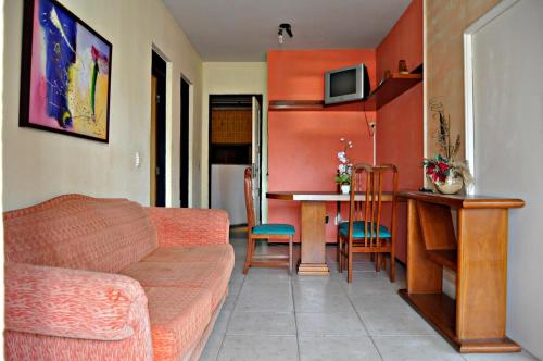 a living room with a couch and a table at Fortaleza Flat Executivo in Fortaleza