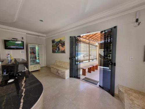 a living room with a door open to a living room at Pousada Águas Douradas in Aracaju