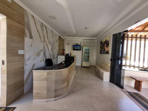 a lobby with a reception desk in a building at Pousada Águas Douradas in Aracaju