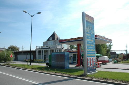 a gas station with a sign in front of it at Vila Lux Milikic in Kraljevo