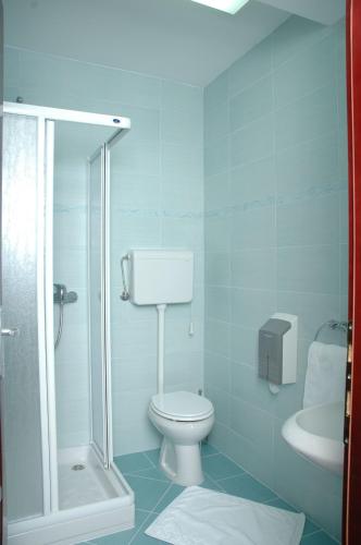 a blue bathroom with a toilet and a sink at Vila Lux Milikic in Kraljevo
