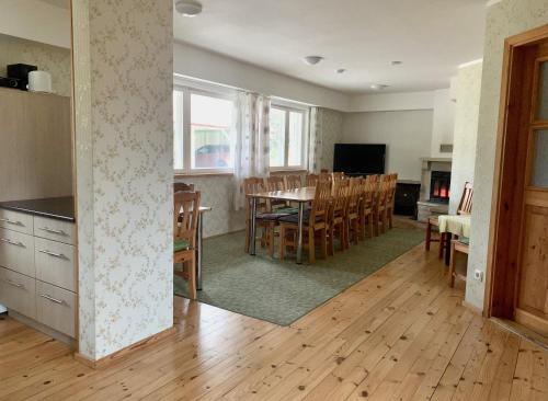 a kitchen and dining room with a table and chairs at Holiday Home Veskijõe in Vaisi