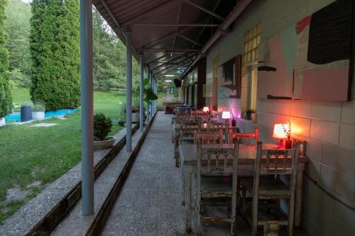 a row of tables and chairs on the side of a building at Camping Alta Ribagorça in El Pont de Suert