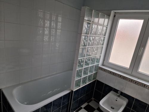 a bathroom with a tub and a toilet and a sink at Apartmani Carla in Medulin