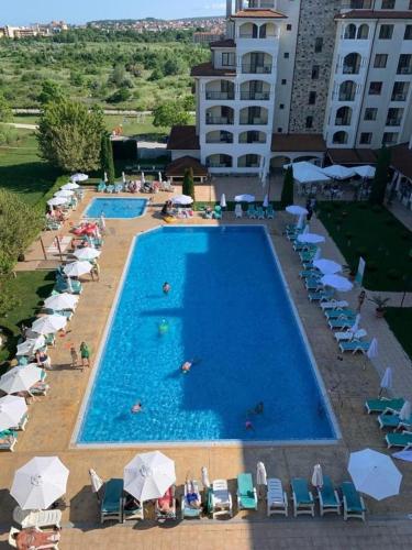 an overhead view of a swimming pool with chairs and umbrellas at Sunrise Splendid in Obzor