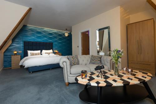 a living room with a bed and a couch and a table at Marine Lodge in Great Yarmouth