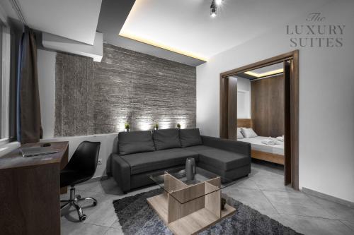 a living room with a couch and a bedroom at Adelle Apartments, The Luxury Suites in Thessaloniki
