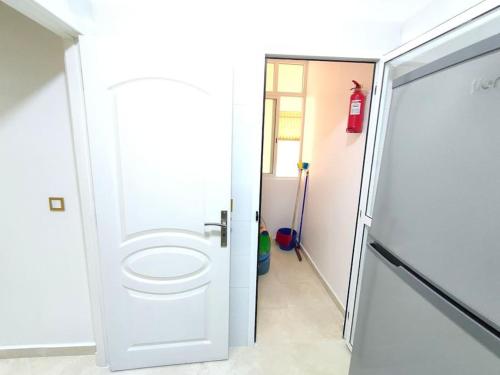 a bathroom with a toilet next to a door at Merveilleux Appartement pour un séjour de Top. in Tangier