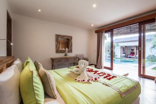 a bedroom with a large bed with a chicken on it at Lovely Canggu 4BR Private Pool Villa with Sundeck! 10mins Ride to Beach in Canggu