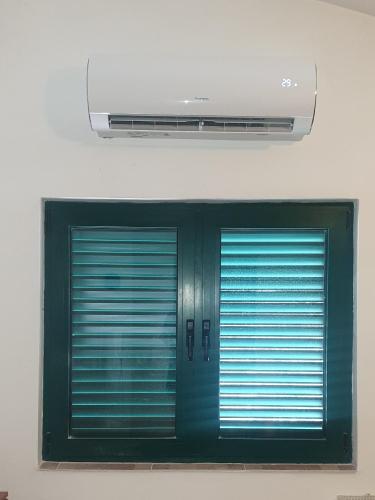 two green doors in a room with a ceiling at Apartments Nena 3* in Ližnjan
