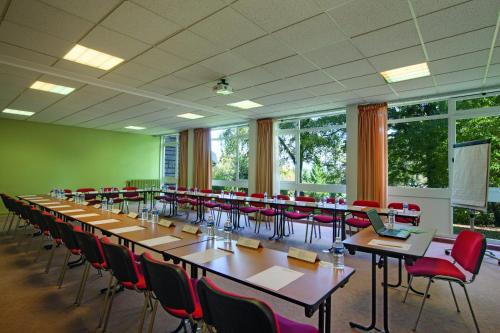 a large room with a long table and chairs at Hotel Belambra Le Normont in Dourdan