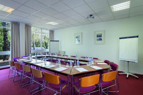 a large conference room with a large table and chairs at Hotel Belambra Le Normont in Dourdan