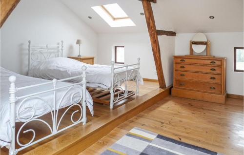 a bedroom with a white bed and a wooden dresser at Cozy Home In Monfaucon With Wifi in Monfaucon