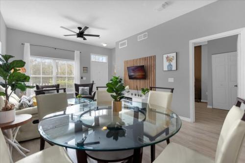 a dining room and living room with a glass table at Seven Dwarfs 10-105 Lc - 3 Bedrooms 2 Bathrooms in Orlando