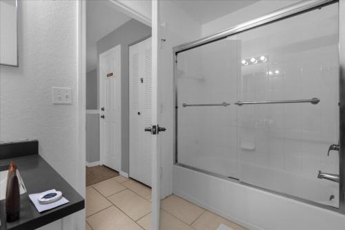 a bathroom with a shower and a glass door at Seven Dwarfs 10-105 Lc - 3 Bedrooms 2 Bathrooms in Orlando