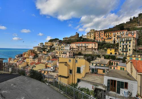 a group of buildings on a hill next to the ocean at Affittacamere Le Giare in Riomaggiore