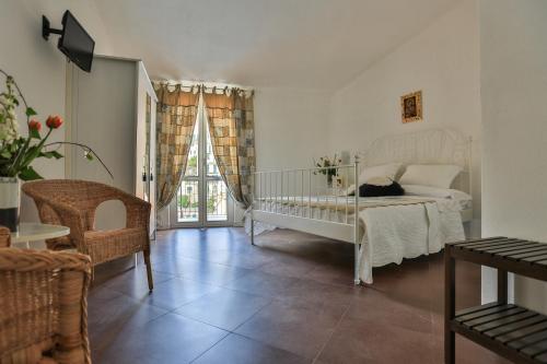 a bedroom with a white bed and a window at Affittacamere Le Giare in Riomaggiore