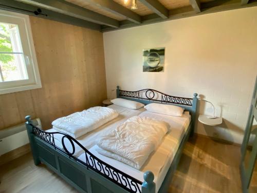 a bedroom with two beds in a room with a window at Ferienhaus mit Wasserterrasse - mit Sauna und Kamin - inklusive Nebenkosten in Wendisch Rietz