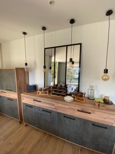 a kitchen with a counter with a large mirror at Hôtel Le Picardy in Saint-Dizier