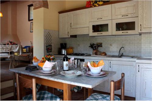 a kitchen with a table with bowls of fruit on it at Poderi Val Verde in Castellina in Chianti