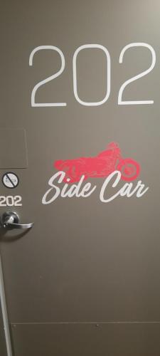 a door with a side car sign on it at hotelF1 Compiègne in Venette