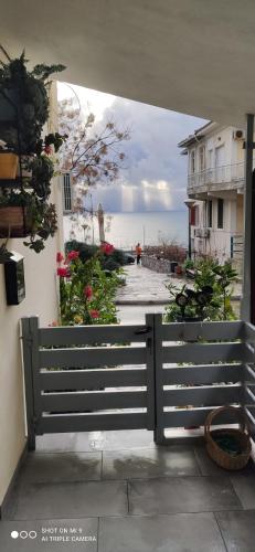 a fence with a view of the ocean from a house at Margarita's House 2 in Kavála