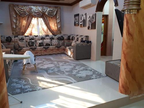 a living room with a couch and a rug at The calm place in Nizwa in Al Jināh