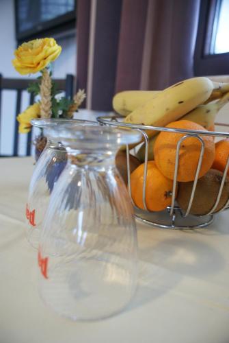 a bowl of fruit with bananas and oranges on a table at Gästehaus Elisabeth in Radstadt