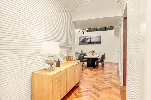 a dining room with a table and a lamp at 108MM House in Porto