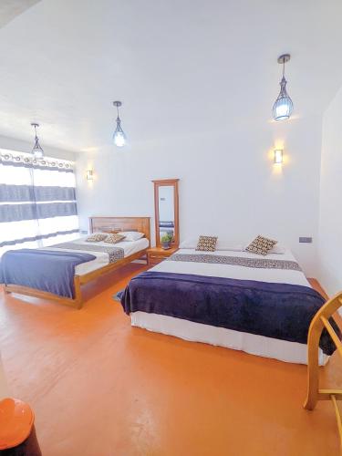 a bedroom with two beds and a window at White Home in Haputale