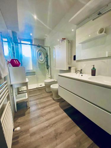 a white bathroom with a sink and a toilet at FRESH HOME in Turin