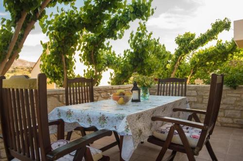 a table with a bowl of fruit on a patio at Vidakis Villas 4 in Sívas