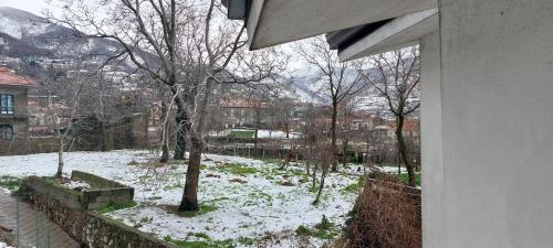 a view of a snow covered yard from a window at Haidi House in Agerola