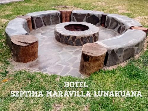 a fire pit in the middle of a field at Hotel Septima Maravilla Lunahuana in Lunahuaná