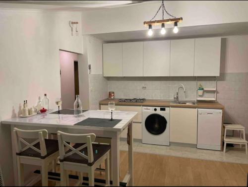 a kitchen with a table and a sink and a dishwasher at SEAWAY in Zavalatica
