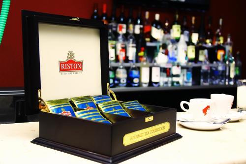 a box of chocolates sitting on a table in front of a bar at Hotel Shine Palace in Tbilisi City