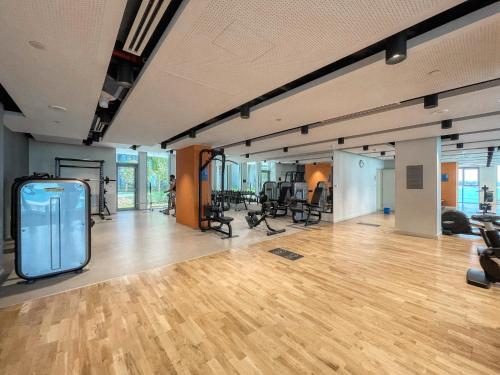 a gym with a wooden floor and chairs in a room at Welcome Home - Bluewaters brand new 2-bedroom in Dubai