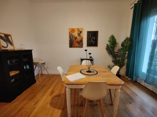 a dining room with a wooden table and chairs at L'appart du Canal in Carcassonne