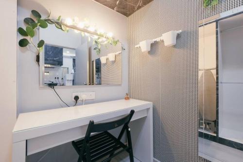 a bathroom with a mirror and a black chair at Mini House Gombak 2BR 5pax Ayuman Suites in Kuala Lumpur