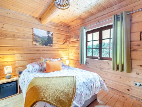 a bedroom with a bed in a wooden cabin at Ty Afal - Uk42099 in Carno