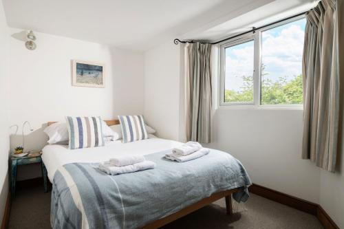 a bedroom with a bed with two towels on it at Sundeck in Brixham