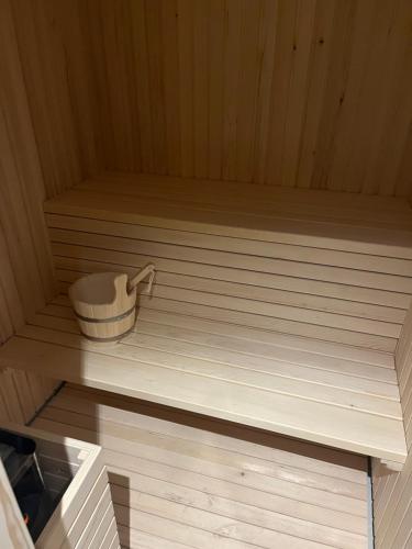 a sauna with a bowl on a wooden floor at Luxury Apartments Anja in Jahorina